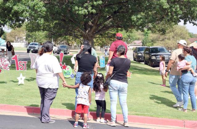 Parents and guardians have their kids pose with the first day of school decorations before Meet the Teacher at Littlefield Primary School on Monday, August 18th. (Photo by Ann Reagan)