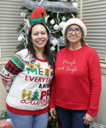 Selena Sanchez Lamb County Librarian and Juanita Fortenberry, member of the Lamb County Library Board were on hand to greet guests at the Lamb County Library Christmas Open House and Gingerbread House contest on Friday, December 15, 2023. (Photo by Ann Reagan)