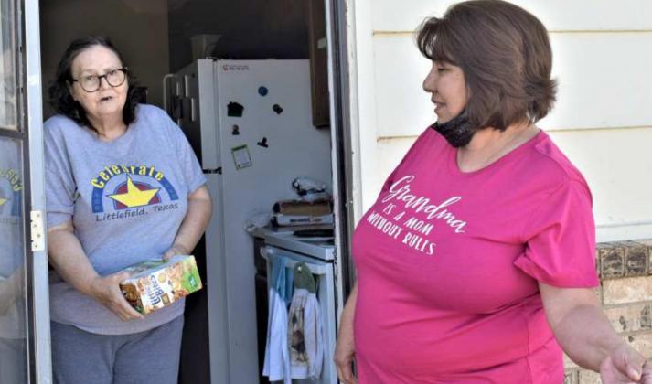 MRS. COOPER RECEIVES DELIVERY – Nicky Frausto visits with Mrs. Cooper, after her food is delivered. (Photo by Ann Reagan)