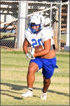 An Olton varsity running back takes the hand-off up the middle, during the Mustang’s intersquad scrimmage on Saturday. (Staff Photo by Derek Lopez)