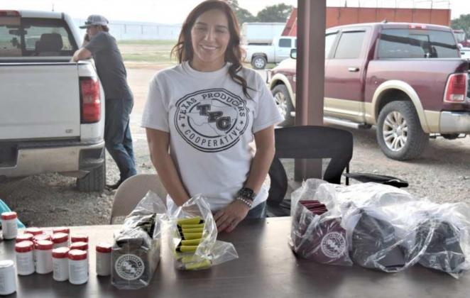 ELYSIA LARA of Amherst an employee of Texas Cotton Producers and Lance Insurance presides at the gift table during the annual Tailgate Party at the Sudan location on Sept. 11, 2021.