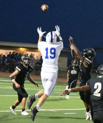 LOOKING FOR A BIG PLAY – Olton junior wide receiver, Brennon Huguley, goes up for a catch between two Sudan defenders, during the third quarter of Fridays contest with the Sudan Hornets in their season-opener. (Staff Photo by Derek Lopez)