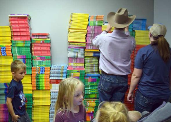PARENTS AND STUDENTS browse the many retired school books offered for free at Camp Read-A-Lot Book Fair. (Photo by Ann Reagan)