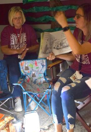 PRIMARY BOOK FAIR -- Mrs. Alcorn provides sound effects and Ms. Garrett reads aloud at their campsite during the Family Reading Night’s Camp Read-A-Lot on November 10, 2022 at Littlefield Primary School. (Photo by Ann Reagan)