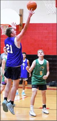 Olton’s Wyatt Nelson (21) drops in a lay-up during the second half of the Mustang’s New Home Team Camp Tournament-opener against New Deal on June 21st. (Staff Photo by Derek Lopez)