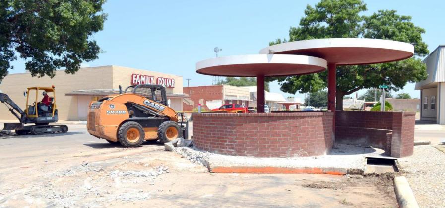 (RIGHT) PART OF THE LARGE ROCK CONCRETE AREA on the Third Street cross-over at Phelps Avenue, which is located on the southeast corner of the intersection, had been removed Thursday, around the covered seating area. This is part of a new downtown Littlefield Revitalization Program that has begun. (Staff Photo by Joella Lovvorn)