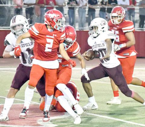 PUSHING FORWARD – Littlefield tailback, Ty’Jae Chambers (20), fights his way through the Denver City defense, getting a lead block from his fullback, Gus McNabb (11), during the Wildcats, 28-14, loss to the Mustangs on Friday. (Staff Photo by Derek Lopez)
