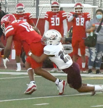 OPEN-FIELD TACKLE, Littlefield cornerback, Joseph Salinas (25), makes an open-field tackle on the Mustang’s receiver, during the Wildcats, 28-14, loss to Denver City on the road on Friday. (Staff Photo by Derek Lopez)