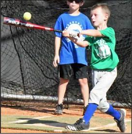 An Olton youth baseball camper makes solid contact during a game of Ragball, during the final day of Baseball Camp in Olton last Thursday. (Staff Photo by Derek Lopez)