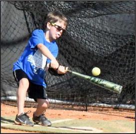 A camper from the morning session of the Olton Youth Baseball Camp gets a hit during a game of Ragball, during the final day of camp last Thursday in Olton. (Staff Photo by Derek Lopez)