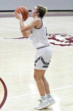 LONG RANGE -Littlefield sophomore, Madison McNeese (12), spots up for a three from the left elbow, during the first half of the Lady Cats’, 50-34, victory over the Tigerettes on Tuesday at Wildcat Gym. (Staff Photo by Derek Lopez)