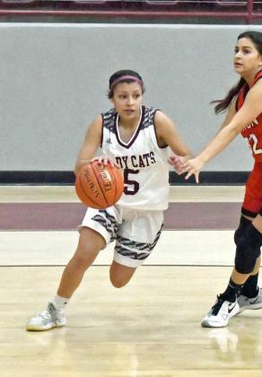DRIVE AND KICK-Littlefield junior guard, Emily Champion (5) drives the baseline and kicks back up to an open Brookelyn Gau on the free-throw line, who knocked down the jumper, during the first half of the Lady Cats’, 50-34, victory over the Tigerettes on Tuesday at Wildcat Gym. (Staff Photo by Derek Lopez)