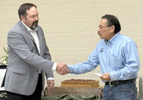 Lamb County Electric Cooperative’s General Manager/CEO Blake Moore congratulates Floyd Trevino for his 50 years of dedicated and unwavering service to LCEC. (Submitted Photo)