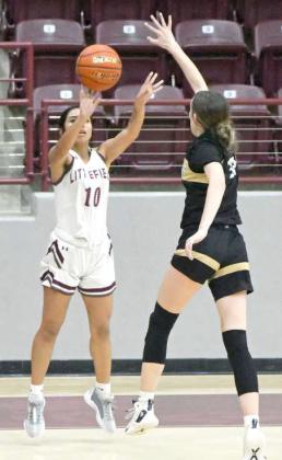 Nevaeh Esquibel drains a three from the right wing over an Andrews defender, during the Lady Cats’ tournament-opener at the Wildcat Classic Wednesday evening. (Staff Photo by Derek Lopez)