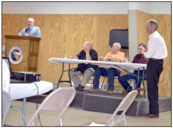 GUYLE ROBERSON, (right, standing) CEO of Texas Producers Cooperative of Amherst and Sudan, was waiting his turn to report on the Cooperative’s ginning season, while the Stockholders were receiving another report. (Staff Photo by Joella Lovvorn)