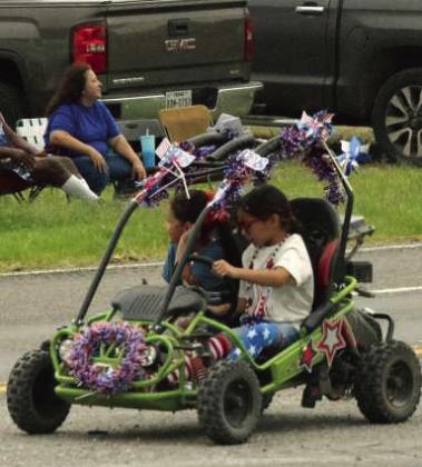 Kids ride toy ATVs in the Springlake Fourth of July parade. (Photo by Leon Szaniszlo)
