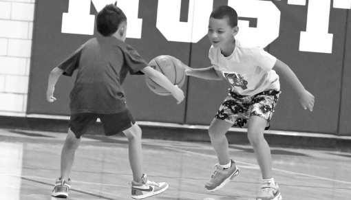Campers work on skills, during a drill at the Mustang Youth Basketball Camp on Monday, May 25th. (Staff Photo by Derek Lopez)