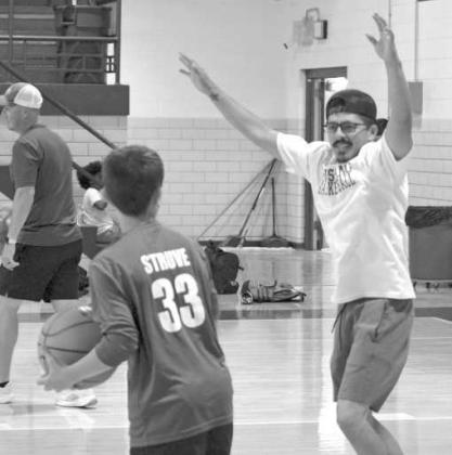Assistant coach Rosario Gonzalez joins campers in a post-practice scrimmage at the Olton Mustang basketball camp on Memorial Day. ( Photo by Leon Szaniszlo)