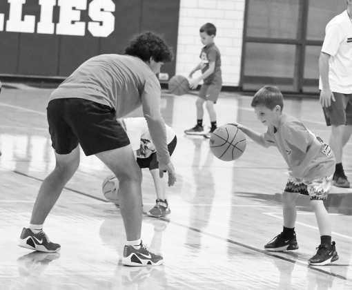 Mustang Youth Basketball campers warm up with some dribbling routines, during the first day of camp on Monday, May 25th. (Staff Photo by Derek Lopez)