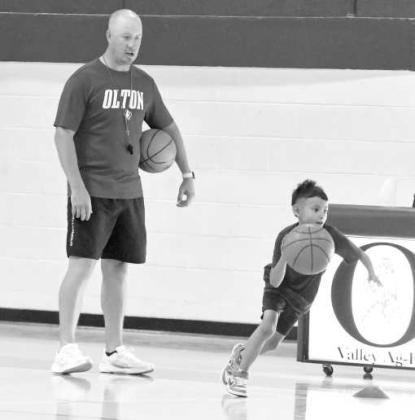 Olton Head Coach Bobby Workman looks on, as campers go through a dribbling drill at the Olton Mustang Youth Basketball Camp on Monday, May 25th. (Staff Photo by Derek Lopez)