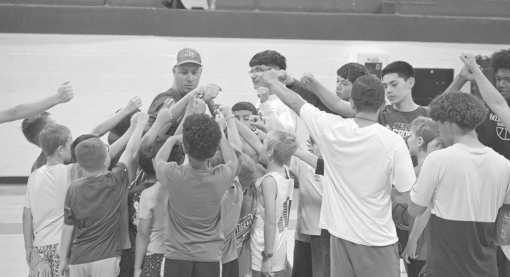Campers and coaches form a team huddle at the end of practice as the group comes together for a final cheer before breaking at the Olton Mustang basketball camp on Memorial Day. (Photo by Leon Szaniszlo)