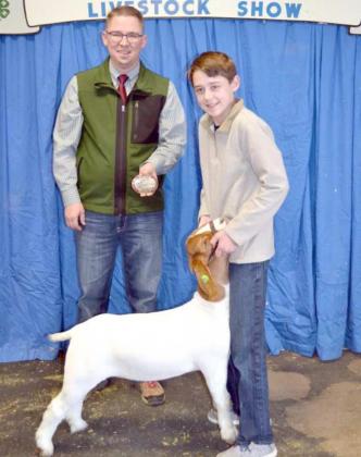 GRAND CHAMPION GOAT, exhibited by Reiner Goe of Springlake-Earth, who is shown with the show judge, Austin Voyles of Canyon. (Staff Photo by Joella Lovvorn)