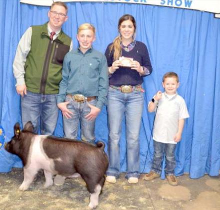 GRAND CHAMPION SWINE was exhibited by Landrea Gonzales of Sudan, shown third from left; and Show Judge Austin Voyles, left. (Staff Photo by Joella Lovvorn)