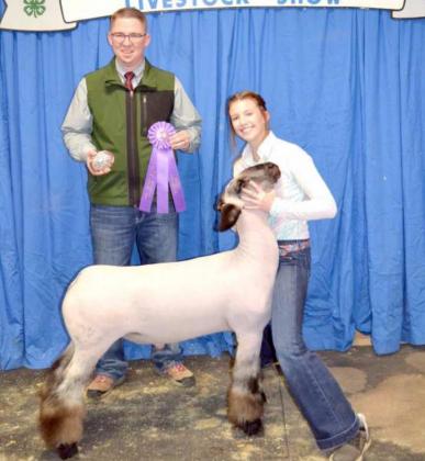 GRAND CHAMPION LAMB, exhibited by Kyndal Edwards of Sudan, are shown with Show Judge Austin Voyles of Canyon. (Staff Photo by Joella Lovvorn)