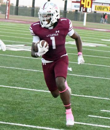 Littlefield senior receiver, Eizeah Coleman (1), catches a pass and cuts it up the Littlefield sideline for a first down, during the first quarter of the Wildcats, 55-36, victory over Slaton on Friday to open district play. (Staff Photo by Derek Lopez)