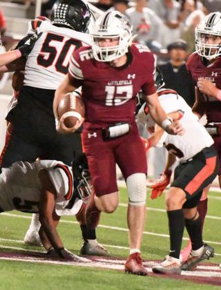 Littlefield senior quarterback, Chip Green (12), breaks into the open field for a solid run, during the second half of the Wildcats, 55-36, victory over Slaton on Friday to open district play. (Staff Photo by Derek Lopez)