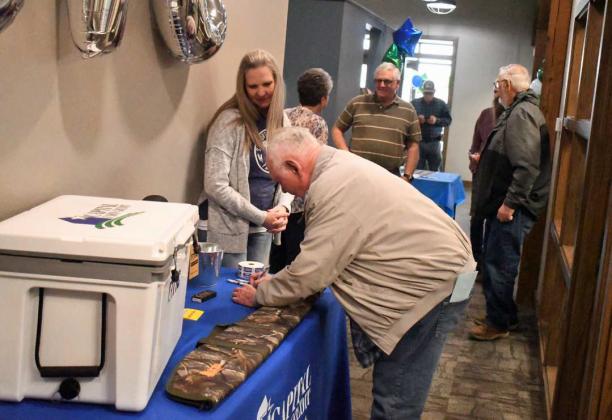 CAPITAL FARM CREDIT LUNCHEON - Capital Farm Credit in Littlefield held a luncheon on Thursday, March 30th, to show their appreciation for their customers continued partnership. Shown are customers signing up to try and win door prizes at the luncheon. (Staff Photo by Derek Lopez)