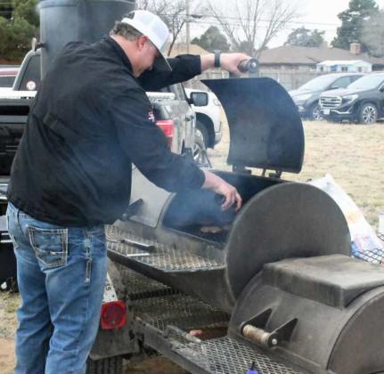 CAPITAL FARM CREDIT LUNCHEON - Capital Farm Credit in Littlefield held a luncheon on Thursday, March 30th, to show their appreciation for their customers continued partnership. Shown is Jason Gandy seasoning up some burgers on the grill for the luncheon. (Staff Photo by Derek Lopez)