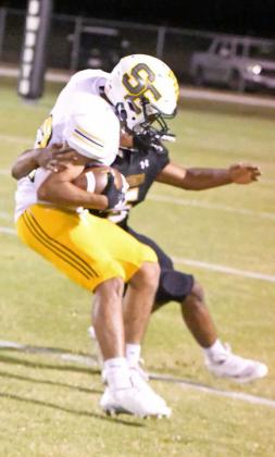 Springlake-Earth’s Kaleb Castillo catches a deep ball from Froylan Agundiz, as he spins out of a tackle on teh sideline taking it in for six, during the second half of the Wolverine’s, 60-34, loss at Happy on Thursday night. (Staff Photo by Derek Lopez)