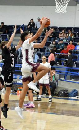 Littlefield junior, Nate Castaneda, gets to the basket for a lay-up, during the fourth quarter of the Wildcats’ victory over Lockney in their Farwell Tournament-opener on Thursday. (Staff Photo by Derek Lopez)