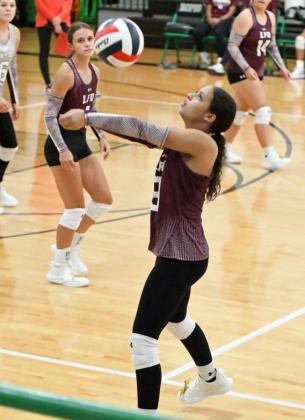 Littlefield’s Madi Williams hits a ball up in the air on the sideline to keep it in play, as the Lady Cats look to go on the attack, during their first set with Ropes on Tuesday. (Staff Photo by Derek Lopez)