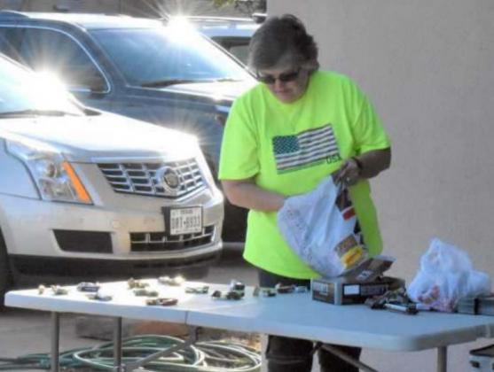 KIM BILLLINGSLEY represents Hillcrest Funeral Home as she prepares the Halloween goodies for the kiddos who attended the funeral home’s Halloween Trick or Treat Party Saturday evening. (Photo by Krista Carpenter)
