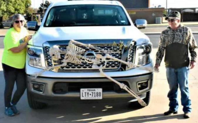 “BONEY” HALLOWEEN FRIENDS—Kim and Sam Billingsley of Hillcrest Funeral Home are shown with some of their “honey” friends. One is shown here on the front, while another is in the bed of the pickup. (Photo by Krista Carpenter)
