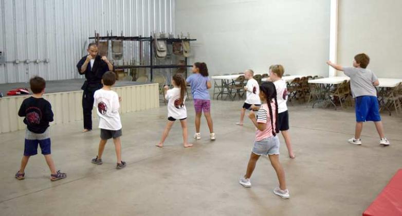 MARTIAL ARTS - Instructor Hutchison McWilliams works with his Little Dragons Class on Tuesday, August. 1st, at Zeke’s, located on Waylon Jennings Ave. (Photo by Ann Reagan)