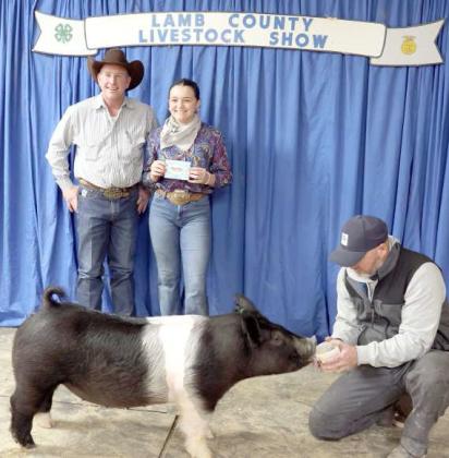 Emry Humphreys of Sudan and her Pig earned Grand Champion Cross Pig at the Lamb County Junior Livestock Show that took place in Littlefield on Saturday. (Photo by Ann Reagan)