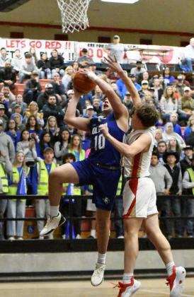 Olton’s Allen Vasquez drives the right side of the basket going up through contact for a lay-up, during the first half of the Mustangs Area Championship victory over West Texas on Friday at Tascosa High School.