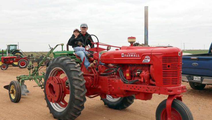 Jayton Moyer and son, Maverick are headed for the field at the Annual SPATA Plow Day held at the Graves Farm of Spade on Saturday, March 22,2024. (Photo by Ann Reagan)