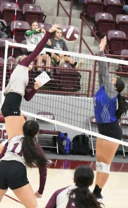 GOING FOR THE KILL – Littlefield’s Madison McNeese rises up and delivers a kill past the block attempt of Olton’s Karla Arriola, during the Lady Cat’s tournament-opener on Thursday with the Fillies. The Lady Cats won the match, 2-1. (Staff Photo by Derek Lopez)