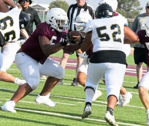 Littlefield’s James Lockridge fires off the offensive line to get a block on the Post defensive lineman, during the Wildcat’s first scrimmage last Friday against Post. (Staff Photo by Derek Lopez)
