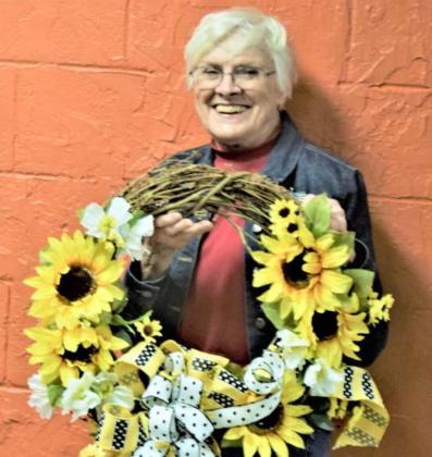 FAREWELL GIFT TO MARJORIE PIERCE—This festive sunflower wreath, made by Donna Hatley, was presented by the Crafty Gardeners to Marjorie Pierce during her farewell party at the Crafty Gardeners’ first spring meeting Tuesday, March 23, 2021 at Loco’s Restaurant. She and her husband, Floyce, are moving from Littlefield to Kiowa Lake, Texas. (Photo by Ann Reagan)