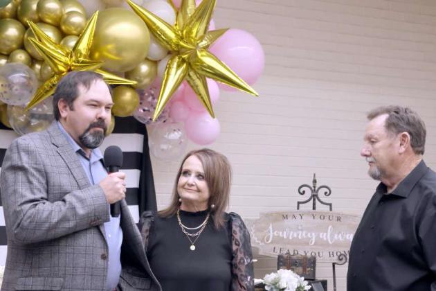 Lamb County Electric Cooperative CEO Blake Moore congratulates Sue Williamson on her retirement as her husband, Johnny Williamson looks on December 21, 2023. Sue started with the company in the 2000. (Photo by Ann Reagan)