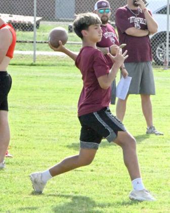 Sammy Saenz drops back for a pass during Littlefield’s first night of 7v7 at Wildcat Field last Monday. (Staff Photo by Derek Lopez)