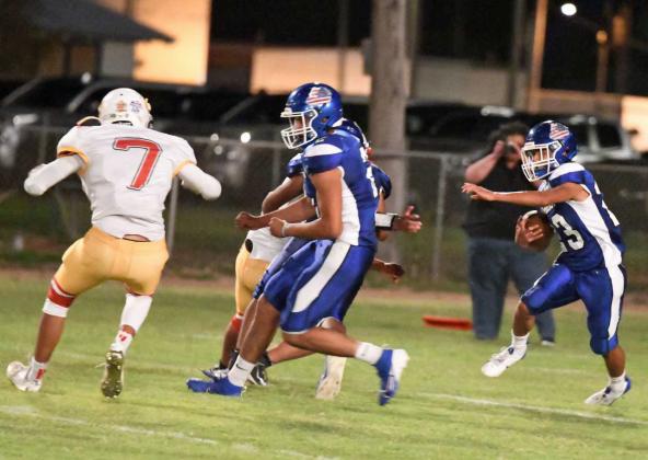 Amherst junior, Aiden Rodriguez (23), cuts back behind a block from junior, Joel Garcia (2), as he sprints up field for a first down to move the chains for Amherst, during their, 54-6, victory over the Christ the King Golden Lions on Thursday at Bulldog Stadium. (Staff Photo by Derek Lopez)