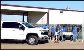 Employees of Lamb County Electric Cooperative serve members as they proceed through the line. Dinners were provided by LCEC and River Smith’s of Lubbock. (Photo by Ann Reagan)