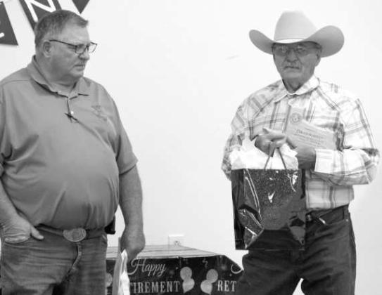 Mayor Blake Cate of Anton, presents a retirement plaque with years of service to Retired Police Chief David Kinney during his retirement party at the Church of Christ on June 30. (Photo by L. Szaniszlo)
