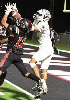 Littlefield’s Jayden Barrio (1), goes up over the defender and makes the grab for a 35- yard touchodwn pass from Sammy Saenz, during the fourth quarter of the Wildcats’, 49-33, loss to Slaton on Friday in their district-opener. (Staff Photo by Derek Lopez)